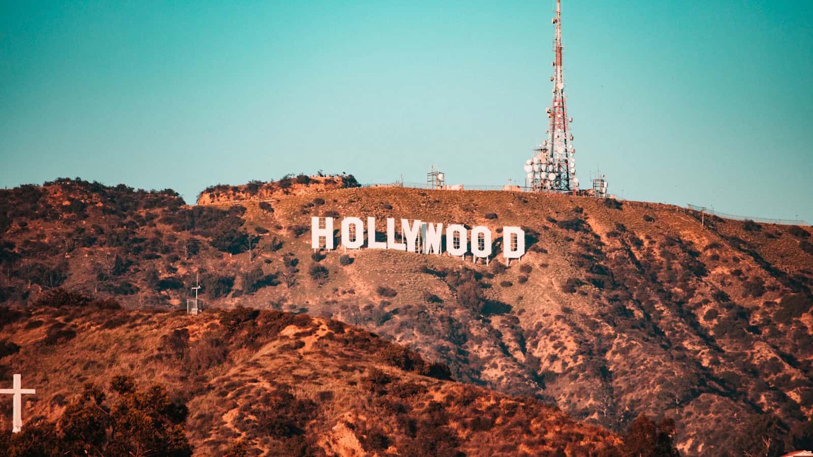 Hollywood sign on a dry hillside under a clear blue sky.