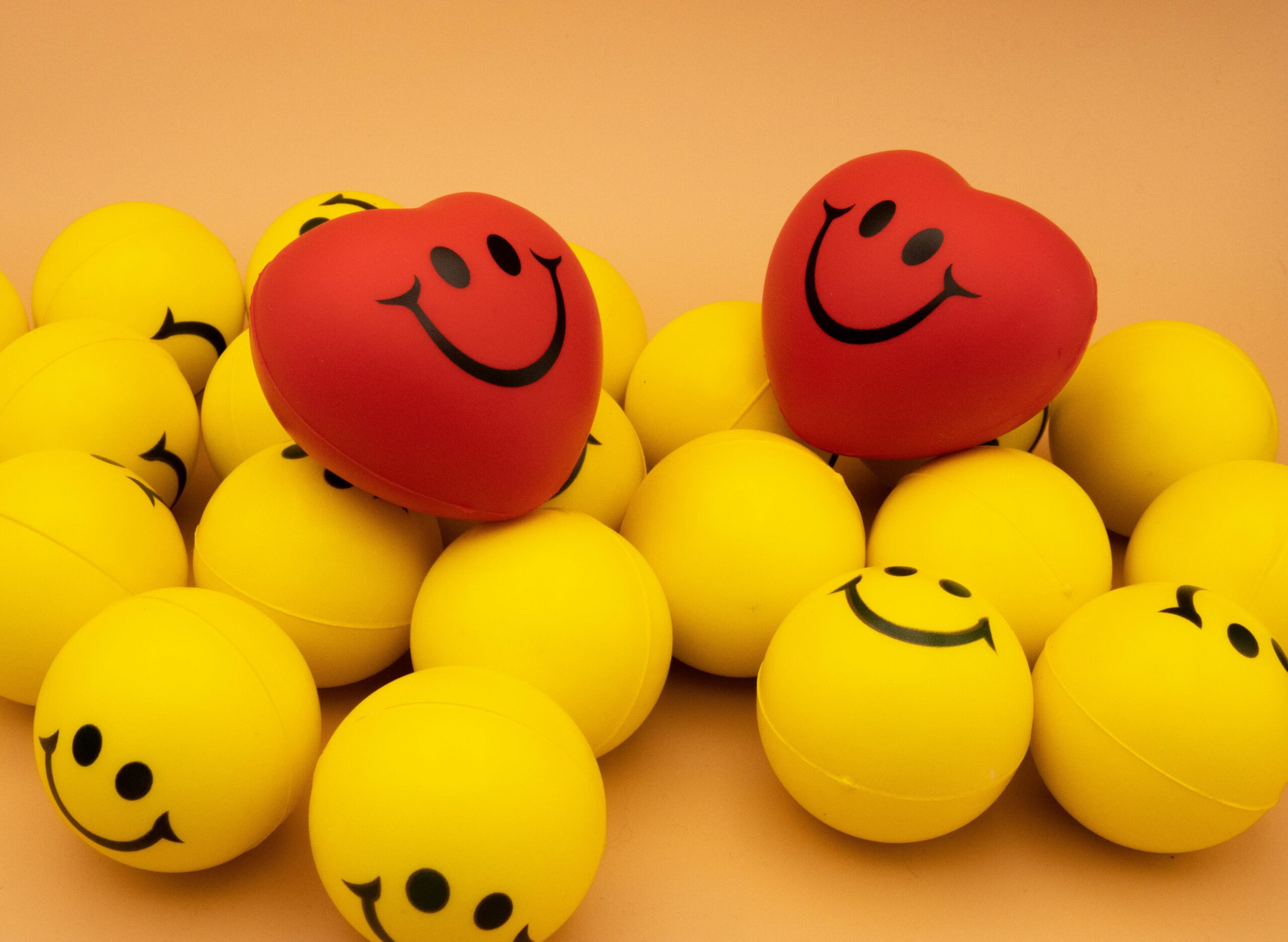 Red and yellow smiley-face stress balls grouped together.
