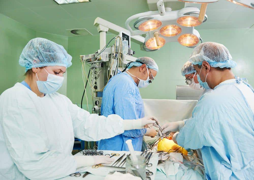 Surgeons performing a lung operation in a hospital operating room.